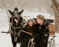 couple with horse drawn carriage in snow
